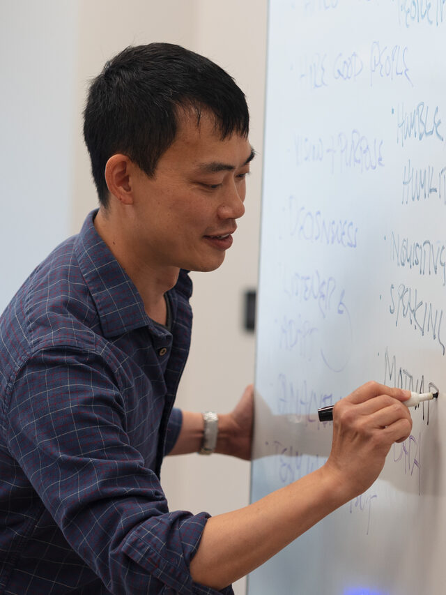 Eric Lin writing on the whiteboard